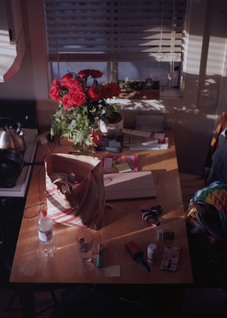 Scattering of personal objects on a kitchen table.